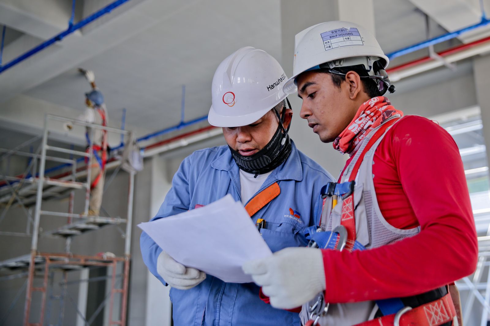 Crew members reviewing project plans on site